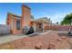View of backyard with covered patio, bbq, and concrete and rock ground cover at 1951 Raspberry Hill Rd, Las Vegas, NV 89142