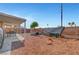 Backyard with small tree, seating area and rock groundcover at 1951 Raspberry Hill Rd, Las Vegas, NV 89142