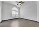Open bedroom with vaulted ceiling, neutral walls, and updated flooring and ceiling fan at 1951 Raspberry Hill Rd, Las Vegas, NV 89142