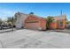 Single Gathering home featuring a two-car garage with a wide concrete driveway and desert landscaping at 1951 Raspberry Hill Rd, Las Vegas, NV 89142