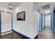 Inviting entry hall features wood floors, white walls with blue trim, and decorative light fixture at 1951 Raspberry Hill Rd, Las Vegas, NV 89142