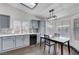 Bright kitchen featuring gray cabinets, white countertops, and a breakfast table with wood flooring at 1951 Raspberry Hill Rd, Las Vegas, NV 89142