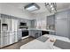 Modern kitchen featuring stainless steel appliances, gray cabinets, white countertops, and wood flooring at 1951 Raspberry Hill Rd, Las Vegas, NV 89142