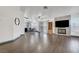 Open-concept living room and dining area featuring a fireplace with media center and wood-look tile floors at 1951 Raspberry Hill Rd, Las Vegas, NV 89142