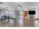 Open-concept living room and dining area featuring a fireplace with media center and wood-look tile floors at 1951 Raspberry Hill Rd, Las Vegas, NV 89142
