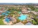 Aerial view showcases community pool, water slides, tennis courts, and recreation areas at 232 Dog Leg Dr, Las Vegas, NV 89148