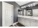 This bathroom features a double sink vanity and expansive mirror at 232 Dog Leg Dr, Las Vegas, NV 89148