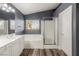 Bright bathroom featuring a soaking tub, glass shower, white cabinets and fixtures at 232 Dog Leg Dr, Las Vegas, NV 89148