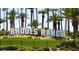 The Rhodes Ranch community sign amidst lush greenery and palm trees in a well-maintained landscape at 232 Dog Leg Dr, Las Vegas, NV 89148