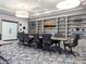 Spacious conference room with large table, office chairs, decorative shelving, and modern carpet at 232 Dog Leg Dr, Las Vegas, NV 89148