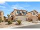 Charming two-story home with neutral stucco, a two-car garage, and drought-tolerant landscaping at 232 Dog Leg Dr, Las Vegas, NV 89148
