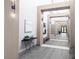 Inviting hallway with stylish decor, modern lighting fixtures, light-colored walls, and bench seating at 232 Dog Leg Dr, Las Vegas, NV 89148