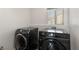 Laundry room with new black front load washer and dryer at 232 Dog Leg Dr, Las Vegas, NV 89148