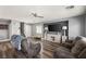 Spacious living room with wood floors, a ceiling fan, and comfortable seating at 232 Dog Leg Dr, Las Vegas, NV 89148