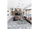 A lounge featuring a stone fireplace, modern lighting, comfortable couches, and elegant decor at 232 Dog Leg Dr, Las Vegas, NV 89148