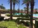 Lush landscaping surrounding a swimming pool with lounge chairs and a view of the community at 232 Dog Leg Dr, Las Vegas, NV 89148