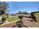 Landscaped backyard featuring lawn, gravel, shrubs, trees and a fenced pool area at 2381 Marion St, Las Vegas, NV 89104