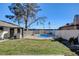A backyard with a pool surrounded by a fence and grass at 2381 Marion St, Las Vegas, NV 89104