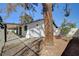 Covered patio in a fenced backyard with mature trees at 2381 Marion St, Las Vegas, NV 89104