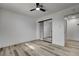 Bright bedroom features wood floors, recessed lighting, ceiling fan, and a mirrored closet for plenty of storage at 2381 Marion St, Las Vegas, NV 89104