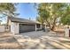 Charming single-story home with a well-manicured front yard and a gray two car garage at 2381 Marion St, Las Vegas, NV 89104