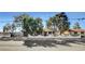 Lovely home featuring mature trees and a decorative fence with a gated entrance, creating a private and welcoming atmosphere at 2381 Marion St, Las Vegas, NV 89104