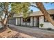 Inviting single-story home featuring a garage and landscaped front yard, with a charming walkway to the front door at 2381 Marion St, Las Vegas, NV 89104