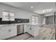 Open kitchen with white cabinets, stainless steel appliances, and breakfast bar at 2381 Marion St, Las Vegas, NV 89104
