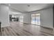 Open-concept living area with wood flooring, connecting kitchen and access to a pool at 2381 Marion St, Las Vegas, NV 89104