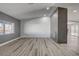 Bright living room with a decorative fireplace accent wall and wood-look floors at 2381 Marion St, Las Vegas, NV 89104