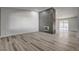 Spacious open living area featuring a decorative fireplace, wood-look floors and neutral walls at 2381 Marion St, Las Vegas, NV 89104