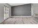 Spacious living room featuring gray accent wall, fireplace, and sliding glass door at 2381 Marion St, Las Vegas, NV 89104