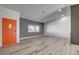 Inviting living room with wood-style flooring, featuring a bright orange front door at 2381 Marion St, Las Vegas, NV 89104