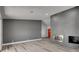 An open-concept living area featuring a modern fireplace and wood-look floors at 2381 Marion St, Las Vegas, NV 89104