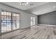 Bright living room with wood-look floors and sliding doors to outdoor space at 2381 Marion St, Las Vegas, NV 89104