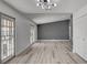 Light-filled living room featuring wood floors, sliding glass door, and gray accent wall at 2381 Marion St, Las Vegas, NV 89104