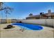 Kidney-shaped pool and concrete patio in backyard is perfect for outdoor entertaining at 2381 Marion St, Las Vegas, NV 89104