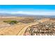 An aerial view shows the home situated in the desert with mountain views and glimpses of the city at 2612 Tullamore Creek Ln, Laughlin, NV 89029