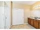 Bright bathroom featuring a glass-enclosed shower, double sinks with granite countertops, and a large closet at 2612 Tullamore Creek Ln, Laughlin, NV 89029