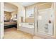 Bright bathroom with a soaking tub, glass shower door and view to a bedroom at 2612 Tullamore Creek Ln, Laughlin, NV 89029