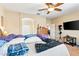 Bedroom showcasing an arched doorway, a ceiling fan, and a window with natural light at 2612 Tullamore Creek Ln, Laughlin, NV 89029