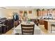 Open dining area featuring a large table with seating, adjacent to the living room and kitchen at 2612 Tullamore Creek Ln, Laughlin, NV 89029