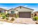 Charming single-story home with a well-manicured front yard and brick-paved driveway leading to a two-car garage at 2612 Tullamore Creek Ln, Laughlin, NV 89029
