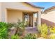 Inviting front entrance with desert landscaping and a cozy porch, enhancing curb appeal at 2612 Tullamore Creek Ln, Laughlin, NV 89029