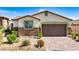Charming single-story home featuring a desert landscape, stone accents, and a two-car garage at 2612 Tullamore Creek Ln, Laughlin, NV 89029