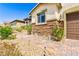 Beautiful home with a charming walkway, stone accents, and desert-friendly landscaping at 2612 Tullamore Creek Ln, Laughlin, NV 89029