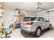 Well-organized garage with a silver car, storage shelves, and ample space for parking at 2612 Tullamore Creek Ln, Laughlin, NV 89029
