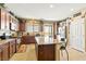 Full kitchen view features a large island, granite countertops, stainless steel appliances, and patio access at 2612 Tullamore Creek Ln, Laughlin, NV 89029
