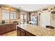 Kitchen featuring a large island, granite countertops, stainless steel appliances, and backyard access at 2612 Tullamore Creek Ln, Laughlin, NV 89029