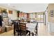 Open-concept kitchen and dining area with cherry cabinets, granite counters, and stainless appliances at 2612 Tullamore Creek Ln, Laughlin, NV 89029